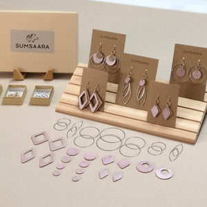 Earwires, jump rings, ear backs, pliers and rose gold color cork fabric pieces in different shapes and sizes packaged in kraft boxes to make earrings