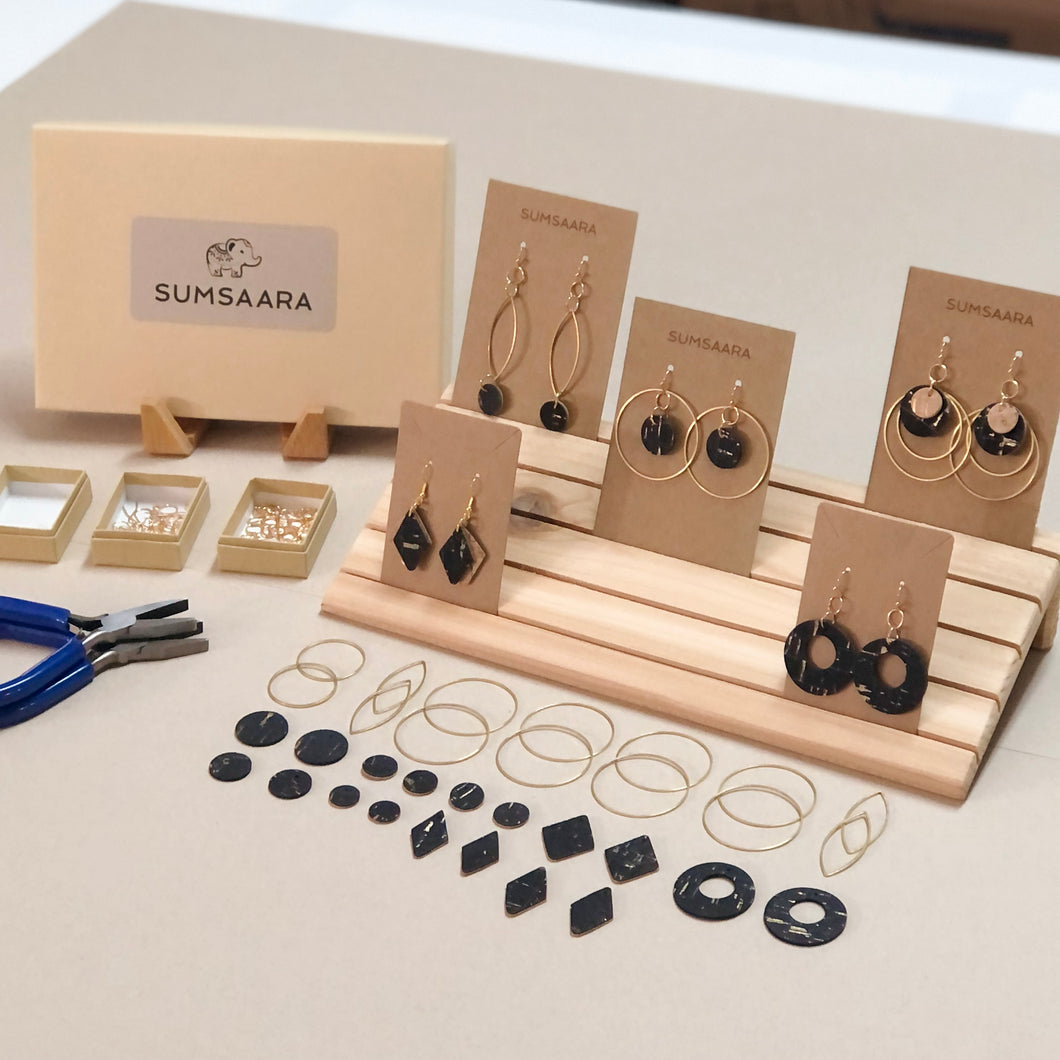 Earwires, jump rings, ear backs, pliers and black color cork fabric pieces in different shapes and sizes packaged in kraft boxes to make earrings